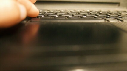 POV: a laptop, close-up shot. Person using a laptop touchpad. Man using a laptop keyboard. A...