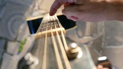 POV: a guitarist holding a guitar. Acoustic guitar, close-up shot. A rusty guitar, top angle. A...