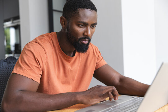 African American male homeowner using laptop at home
