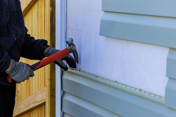 Replacing plastic siding on an exterior wall of residence house