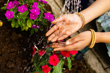 An Indian young woman, washing hands under running water