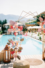 Colorful wedding arch on the edge of the pool