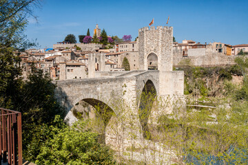 Fototapeta premium The medieval bridge of the village of Besalú, Girona crosses the river to enter the village.