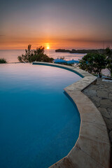 Sunset view from infinity pool beach lounge at Gunung Kidul Yogyakarta Indonesia