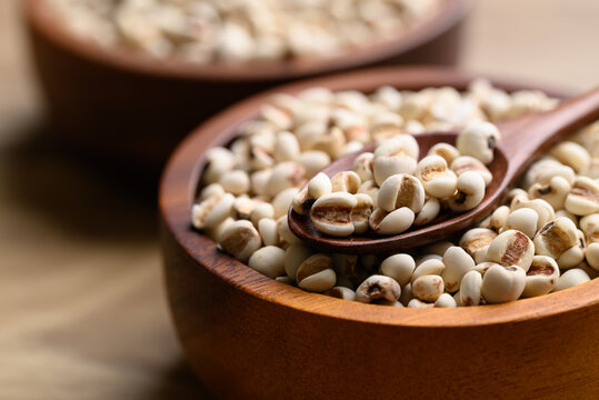 Dried Job's tears or adlay millet in wooden spoon and bowl