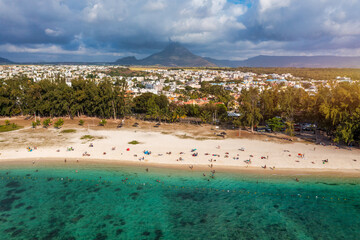 Beach of Flic en Flac with beautiful peaks in the background, Mauritius. Beautiful Mauritius Island with gorgeous beach Flic en Flac, aerial view from drone. Flic en Flac Beach, Mauritius Island.