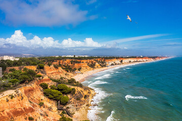 Aerial seascape and coastline cliffs of Praia do Barranco das Belharucas beach, in Algarve region...