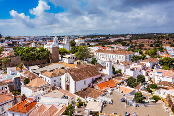 View on historic town of Tavira with Roman bridge over River Gilao, Algarve, Portugal. Cityscape of...