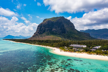 Aerial view of Le morne Brabant in Mauriutius. Tropical crystal ocean with Le Morne mountain and luxury beach in Mauritius. Le Morne beach with palm trees, white sand and luxury resorts, Mauritius.