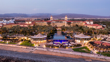 Aerial drone of the popular resort town of Meloneras, with hotels and restaurants, near the...