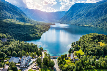 Aerial view of Bohinj lake in Julian Alps. Popular touristic destination in Slovenia. Bohinj Lake, Church of St John the Baptist. Triglav National Park, Julian Alps, Slovenia.