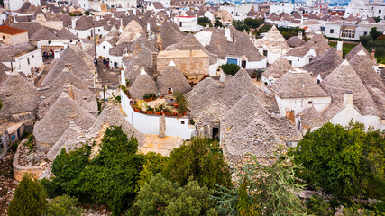 The traditional Trulli houses in Alberobello city, Apulia, Italy. Cityscape over the traditional...