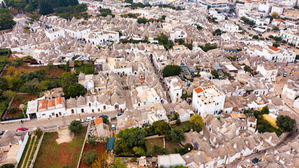 The traditional Trulli houses in Alberobello city, Apulia, Italy. Cityscape over the traditional...