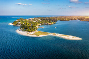 Drone overhead view of the beach of Constance Belle Mare Plage in Mauritius, with palm trees,...