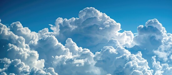 Beautiful fluffy white clouds contrasted with a blue sky.