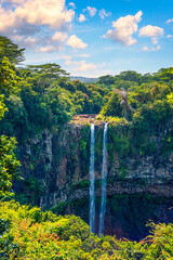 The highest waterfall on the island of Mauritius is Chamarel, whose water falls into the crater of a long-extinct volcano. Exotic nature of tropical paradise of Mauritius island, Chamarel waterfall.