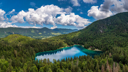 Picturesque lake Lago Fusine in Italy. Fusine lake with Mangart peak on background. Popular travel...