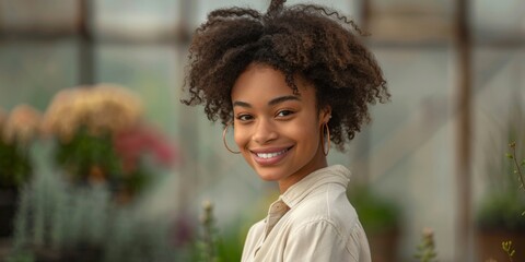 Young Black Woman in Tech-Enhanced Gardening Apparel in Greenhouse