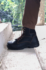 A construction worker wears brown leather boots which look very cool