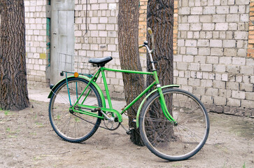 Fototapeta na wymiar An old, retro bicycle is chained to a tree