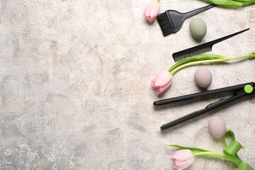 Flattening iron with hairdressing brushes, tulips and Easter eggs on light grunge background
