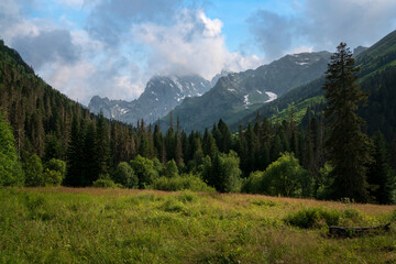 View of Kosygin's glade (Buulu Tala) in the Gonachkhir gorge and the top of Dombai-Ulgen mountain...