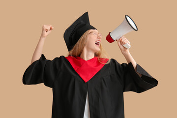 Female graduating student in mortar board with megaphone on brown background