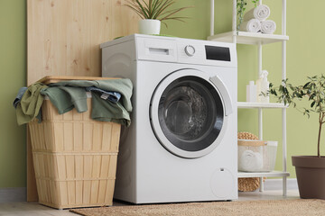 Interior of laundry room with washing machine and basket