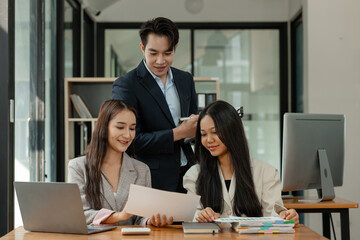 a group of businesspeople is brainstorming in the modern office, working together as a teamwork to share an idea, they are talking about what strategy that they will use for project