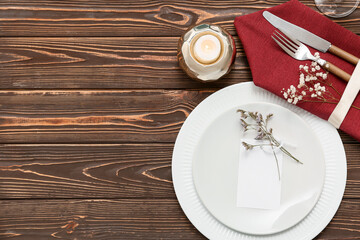 Beautiful table setting with gypsophila flowers and burning candle on wooden background