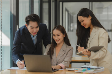 a group of businesspeople is brainstorming in the modern office, working together as a teamwork to share an idea, they are talking about what strategy that they will use for project