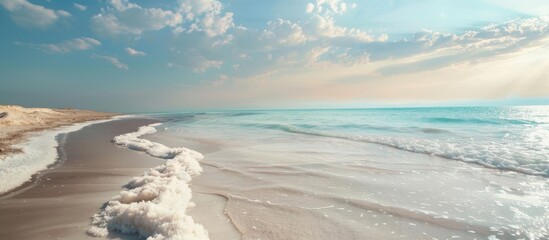 Beautiful beach scene captured on a sunny day, showing waves gently rolling onto the soft sand