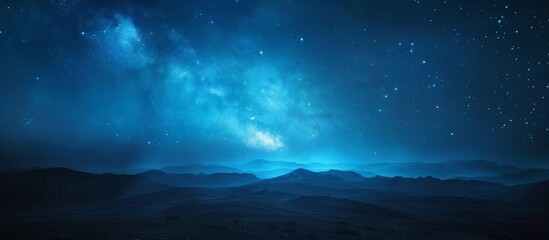 Fototapeta premium Silhouettes of towering mountains under a clear night sky filled with twinkling stars, creating a serene and mystical landscape