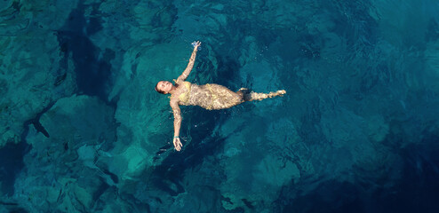 A woman floating and relaxing in the sea  on a sunny day