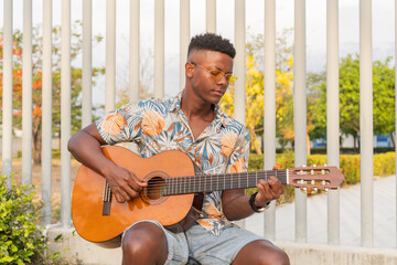 Musician in Sunglasses Playing Guitar in Outdoor Setting