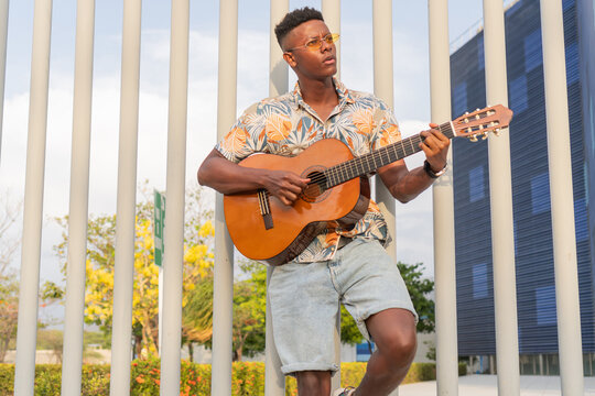 Guitarist in Floral Shirt Performing in Park