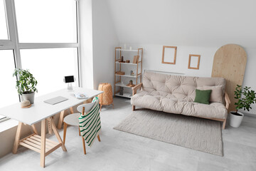 Interior of living room with sofa and workplace