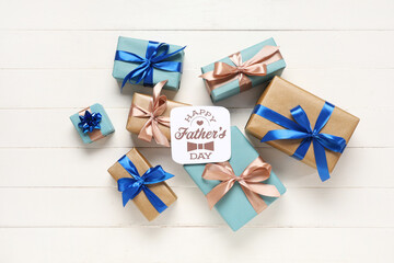 Gift boxes and greeting card with text HAPPY FATHER'S DAY on white background. Top view