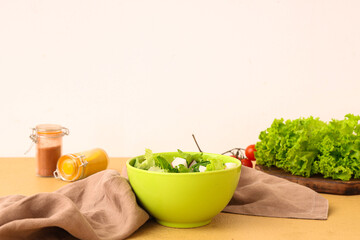 Bowl of tasty salad with radish and ingredients on color table