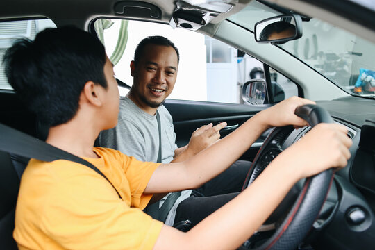 Father  Teaching Teenager Son How to Drive A Car. Driving Course, Car Lesson. 