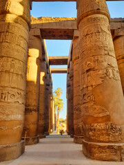 Majestic Hypostyle columns decorated with wall reliefs depicting Pharoahs and Gods at the main...