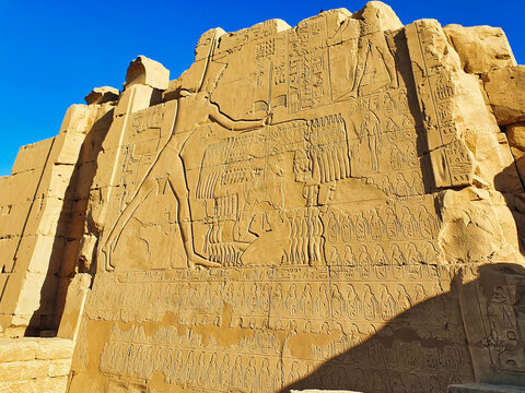 Famous wall bas relief showing the Great Pharoah Thutmosis III slaying Canaanite prisoners at the Battle of Megiddo at the 7th Pylon of the Karnak temple complex dedicated to Amun-Re in Luxor,Egypt