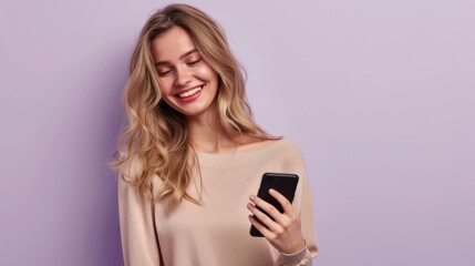 Naklejka premium young smiling woman with a smartphone in her hand on a pink studio background with space for text