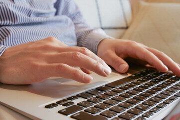 リビングでパソコンを使っている若い男性