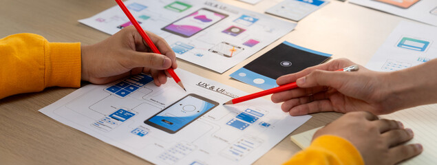 Panorama banner of startup company employee planning on user interface prototype for mobile...