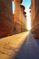 Sun rays illuminate the central passage of the Great Temple of Karnak with majestic hypostyle...