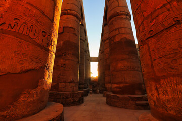 The largest hypostyle gallery in the world is burnished with reddish orange colors in the morning sun at the Karnak temple complex dedicated to Amun-Re in Luxor,Egypt