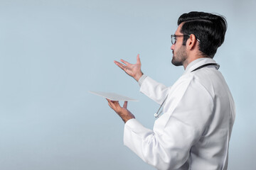 Back view of skilled doctor looking and pointing while holding application form. Professional...