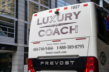 Fototapeta premium Luxury Coach bus in Toronto Downtown. Toronto, Canada - April 29, 2024.