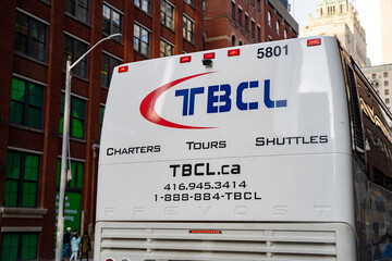 Fototapeta premium Toronto Bus Company Ltd. (TBCL) bus in Toronto Downtown. Toronto, Canada - April 29, 2024.